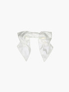 Ivory bamboo silk satin bridal hair bow scrunchie. Set on a white background.