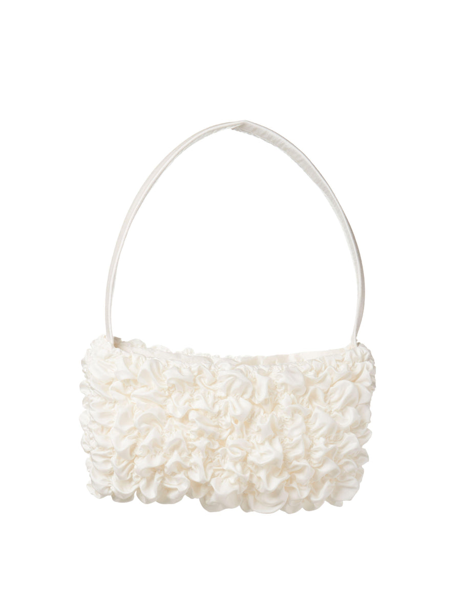 Ivory bamboo silk satin textured ruched front handbag. Set on a white background.
