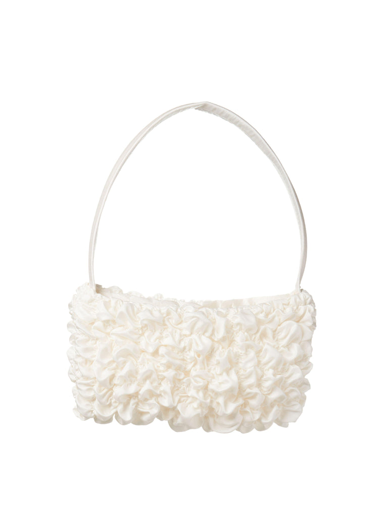 Ivory bamboo silk satin textured ruched front handbag. Set on a white background.