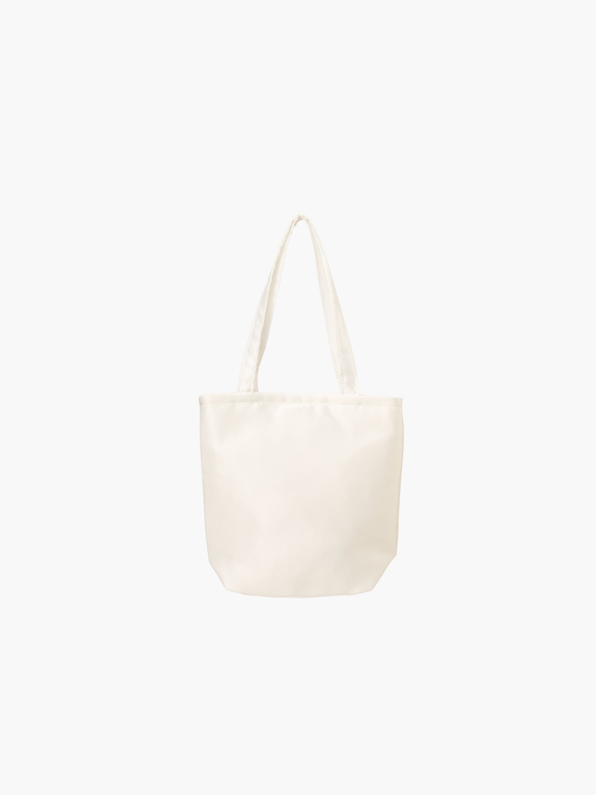 An ivory satin tote bag. It features matching handles, set against a plain white background.