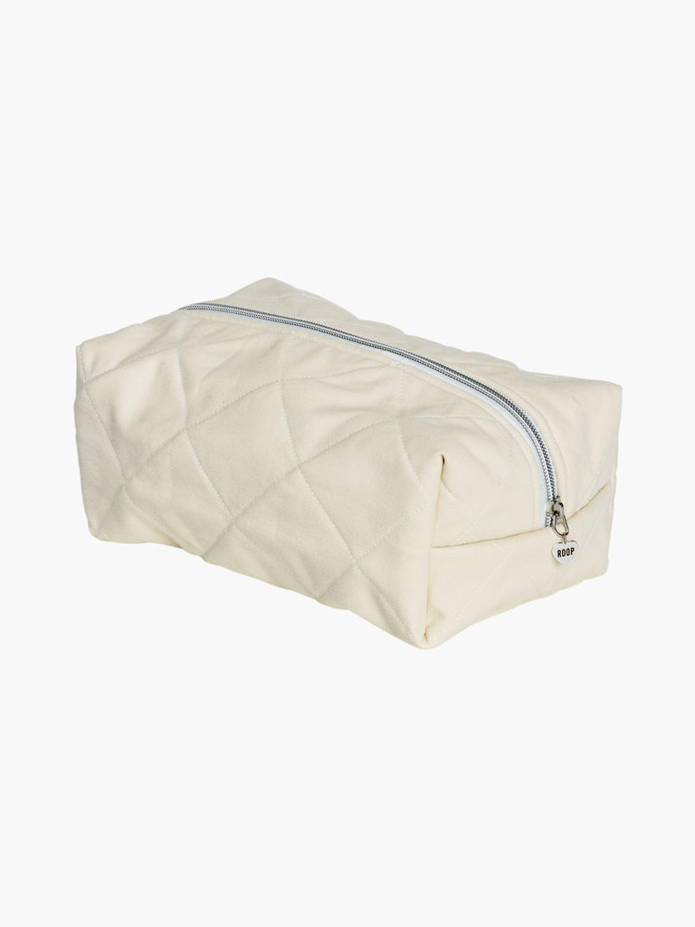 quilted burgundy makeup and toiletry bag with a silver zip with a heart logo zip pull on a white background