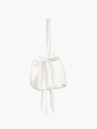 Ivory satin box handbag with a long handle and bow details, set on a white background
