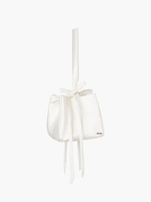 Ivory satin box handbag with a long handle and bow details, set on a white background