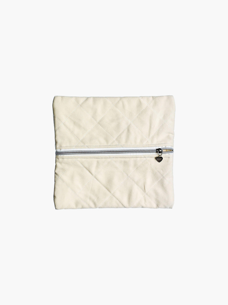 A quilted ivory cotton zipper pouch, the zip has a heart charm on it. Set on a white background.