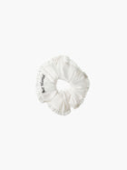 Ivory ruffled scrunchie with black embroidery that reads 'just married' on a white background