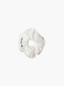 Ivory ruffled scrunchie with black embroidery that reads 'just married' on a white background