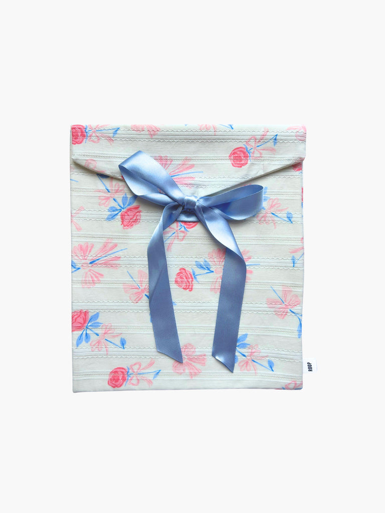 Ribbon tied rose print fabric envelope pouch with a blue ribbon on a white background