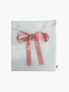 White lace fabric envelope pouch tied with a pink ribbon.