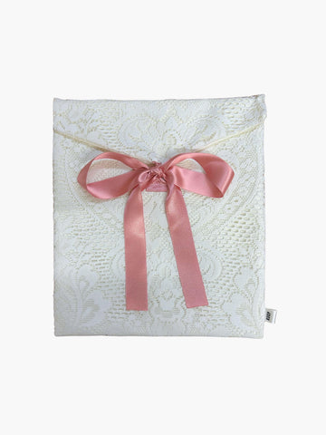 White lace fabric envelope pouch tied with a pink ribbon.