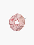 Pink satin scrunchie embroidered with a red heart with the letter A inside, set on a white background