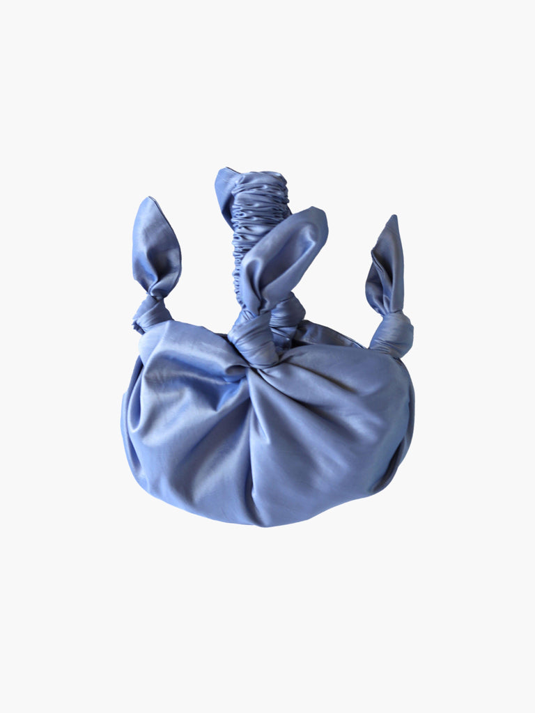 Lilac knotted handbag on a white background