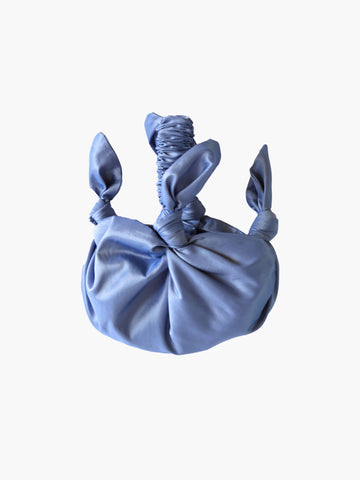 Lilac knotted handbag on a white background