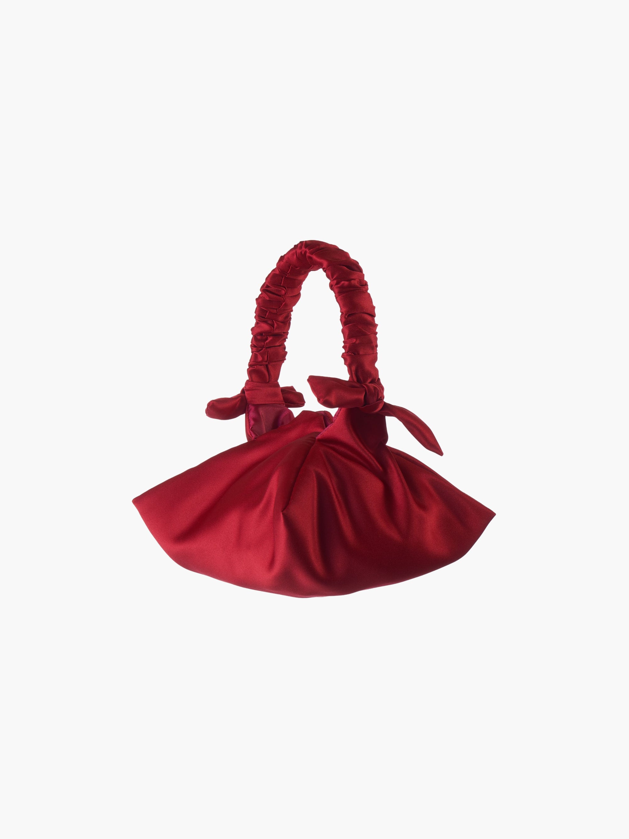 Red satin handbag with ruffled handle on a white background