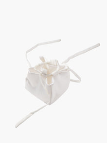 Ivory satin box drawstring handbag with ribbon drawstring details, open to reveal interior, set on a white background