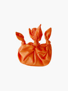 Orange taffeta knotted bag with ruched handle on a white background