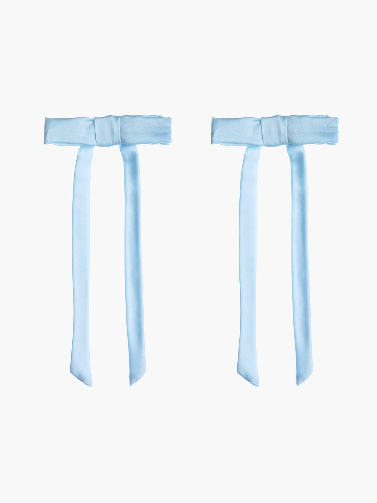 Two light blue satin hair bow clips together on a white background