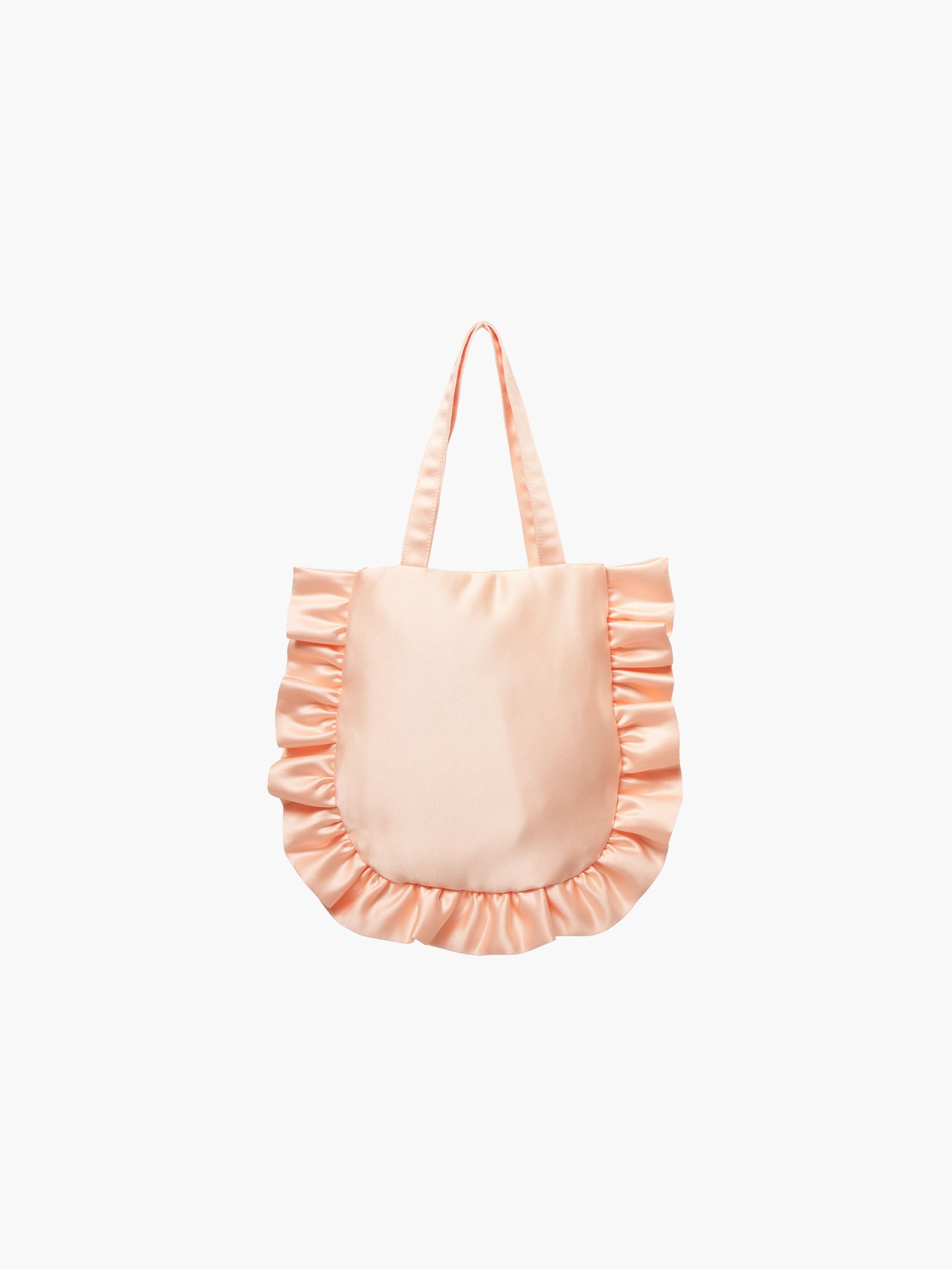 A peach satin tote bag with ruffled edges on the sides and bottom. It features matching handles, set against a plain white background.