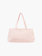 A baby pink satin baguette handbag with two handles.