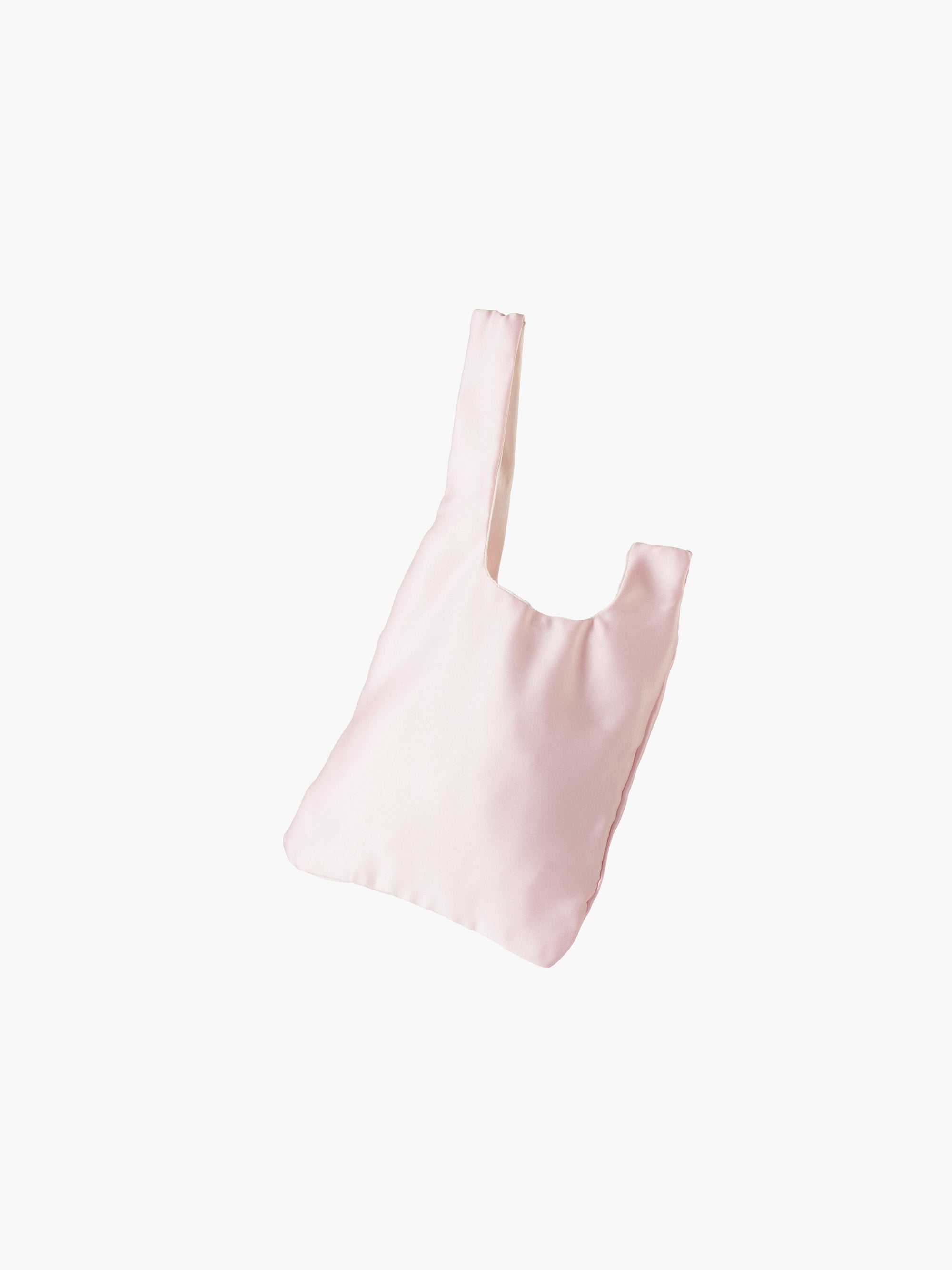 Pink satin knot bag against a plain white background. The elegant bag has a twisted handle and sleek, glossy fabric, exuding a chic, minimalist style.