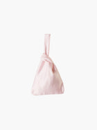 Pink satin knot bag against a plain white background. The elegant bag has a twisted handle and sleek, glossy fabric, exuding a chic, minimalist style.