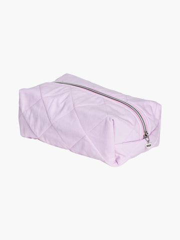 quilted pink makeup and toiletry bag with a silver zip with a heart logo zip pull on a white background