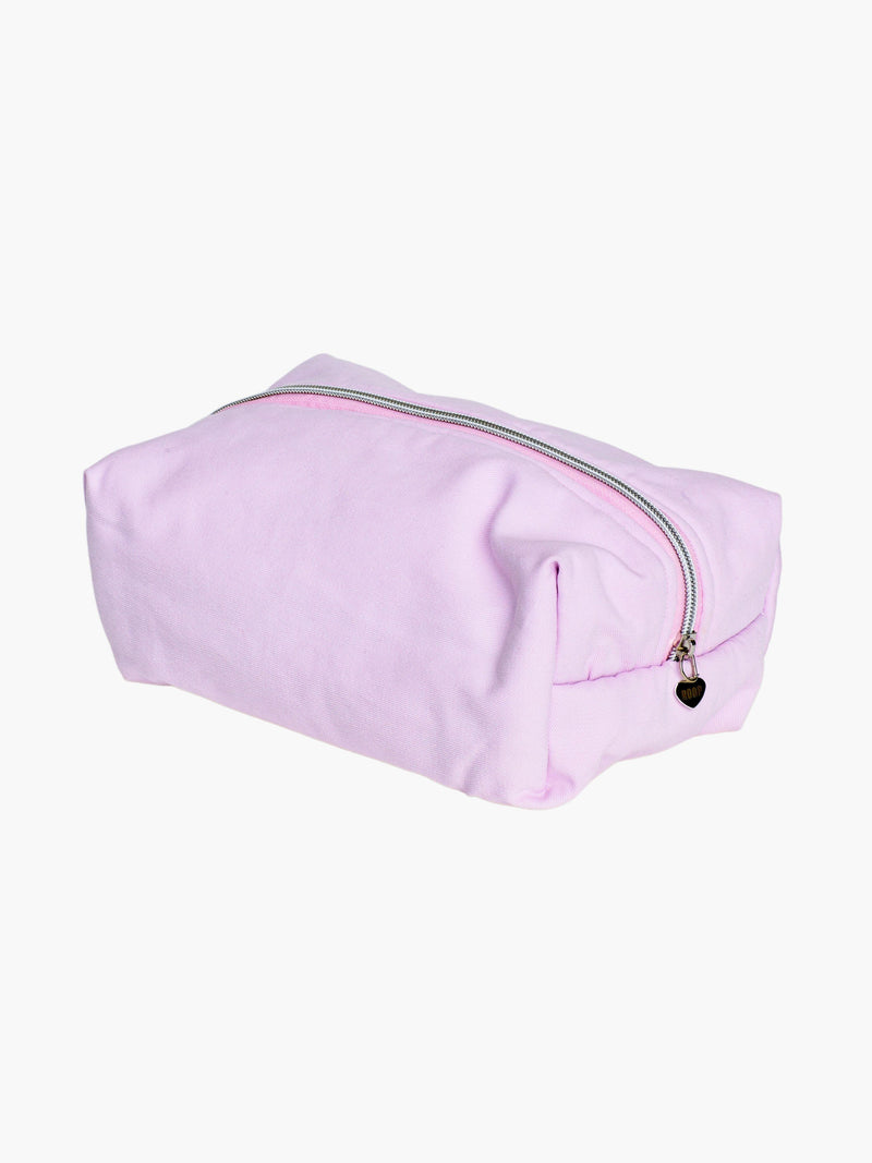 padded pink makeup and toiletry bag with a silver zip with a heart logo zip pull on a white background