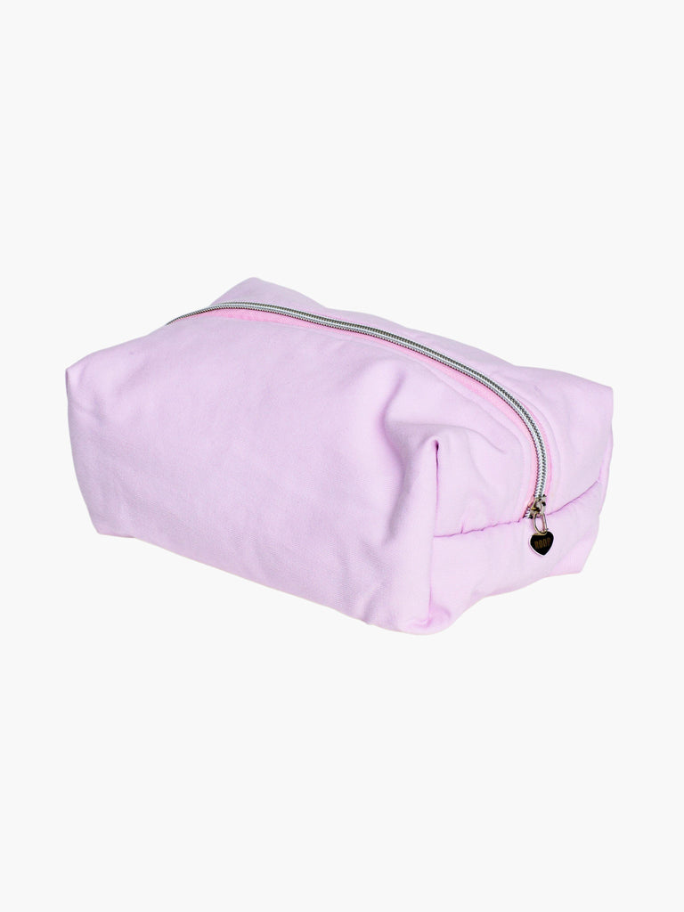 padded pink makeup and toiletry bag with a silver zip with a heart logo zip pull on a white background