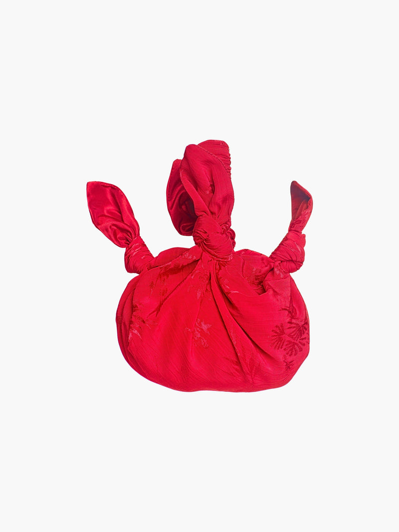 rd floral satin knotted handbag on a white background
