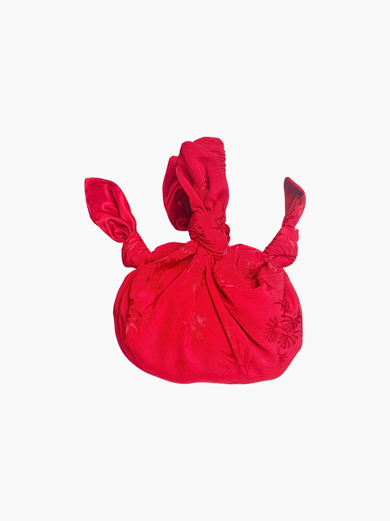 rd floral satin knotted handbag on a white background