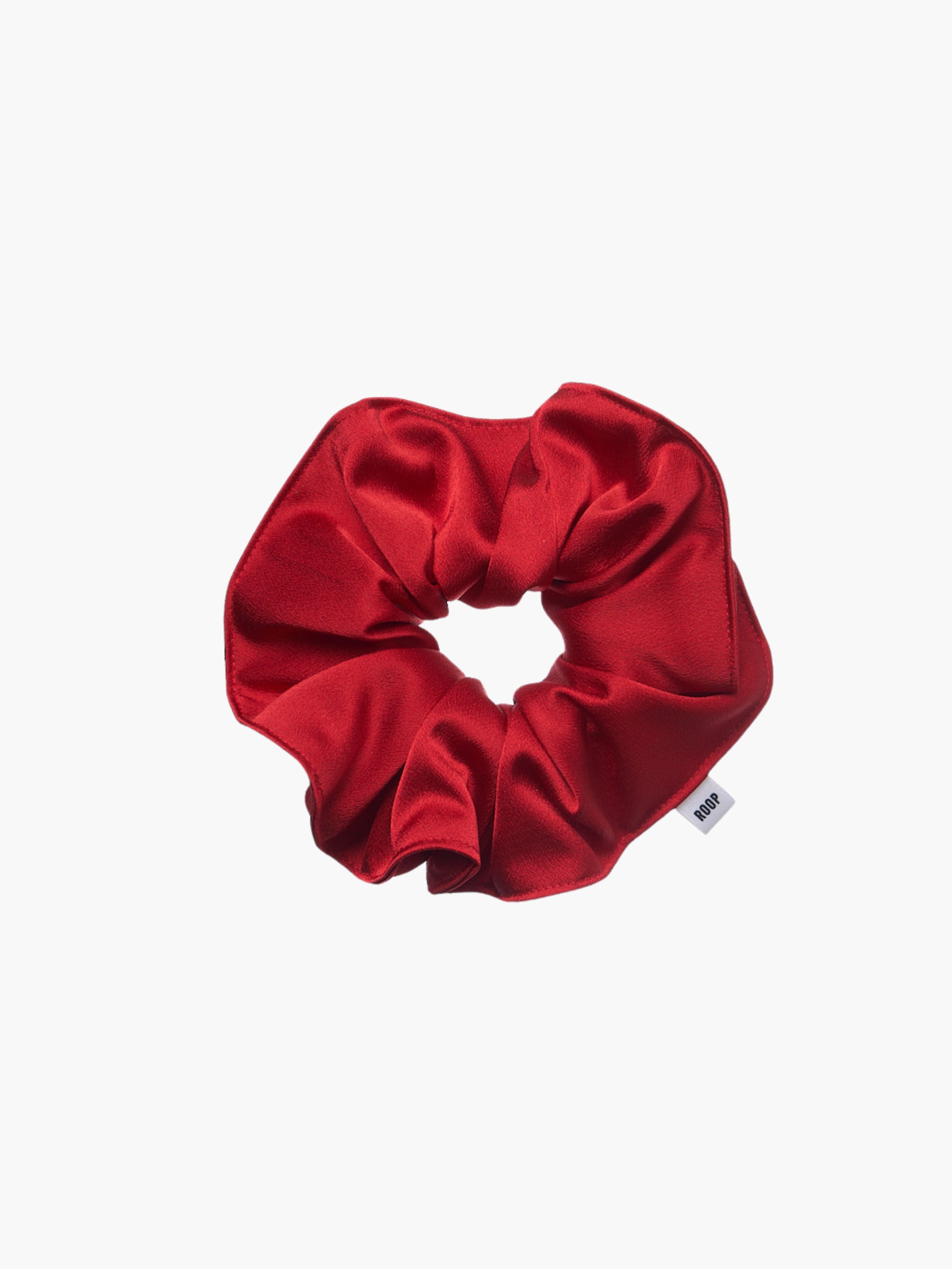 Red satin scrunchie on a white background