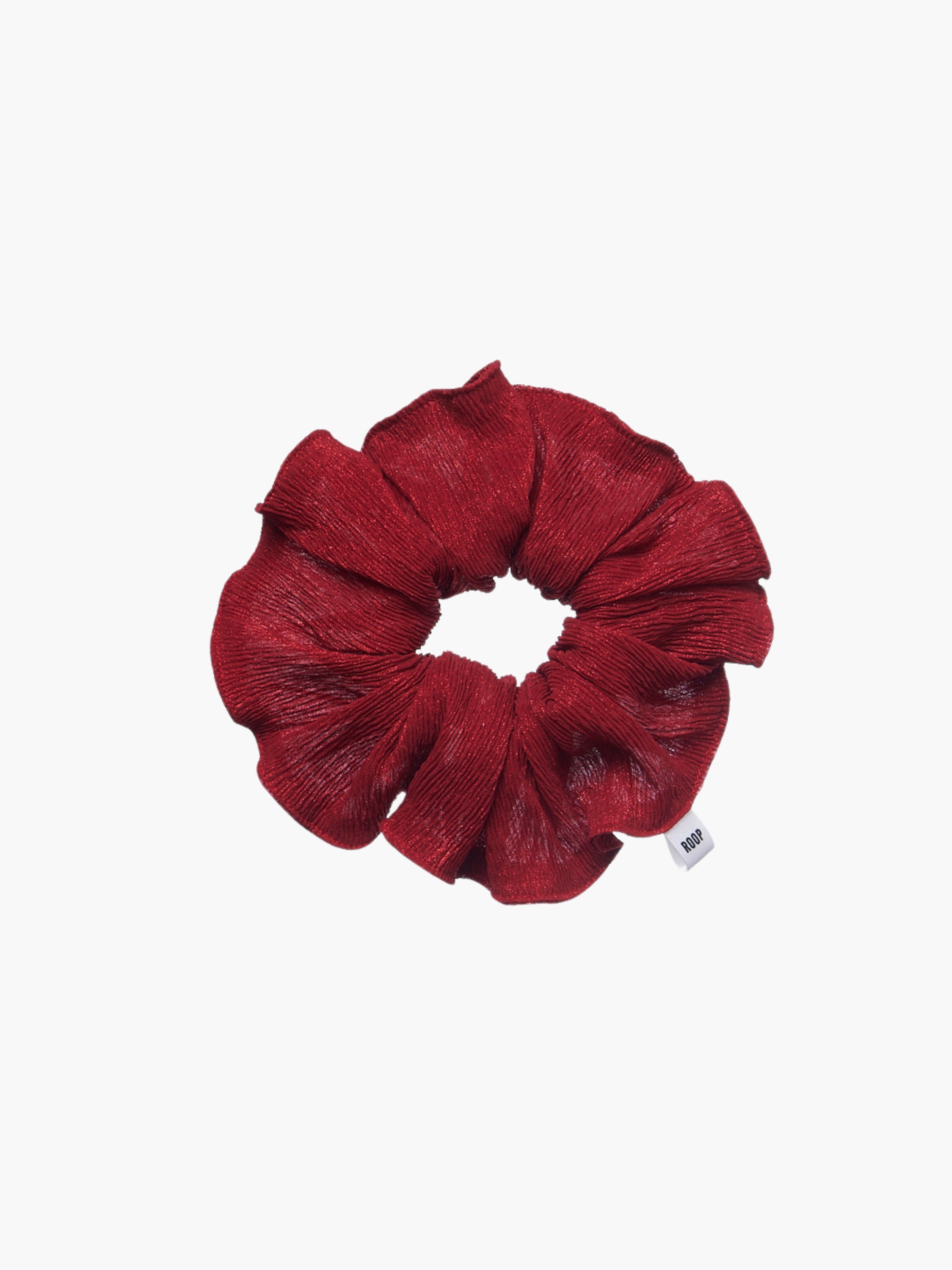 Red glittery scrunchie on a white background