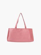 A rectangular pink handbag with double handles, made of silky fabric, is centered against a white background, conveying a simple and elegant style.