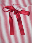 Red striped fabric envelope pouch tied with a red ribbon and 'Lennox' embroidery on the flap.