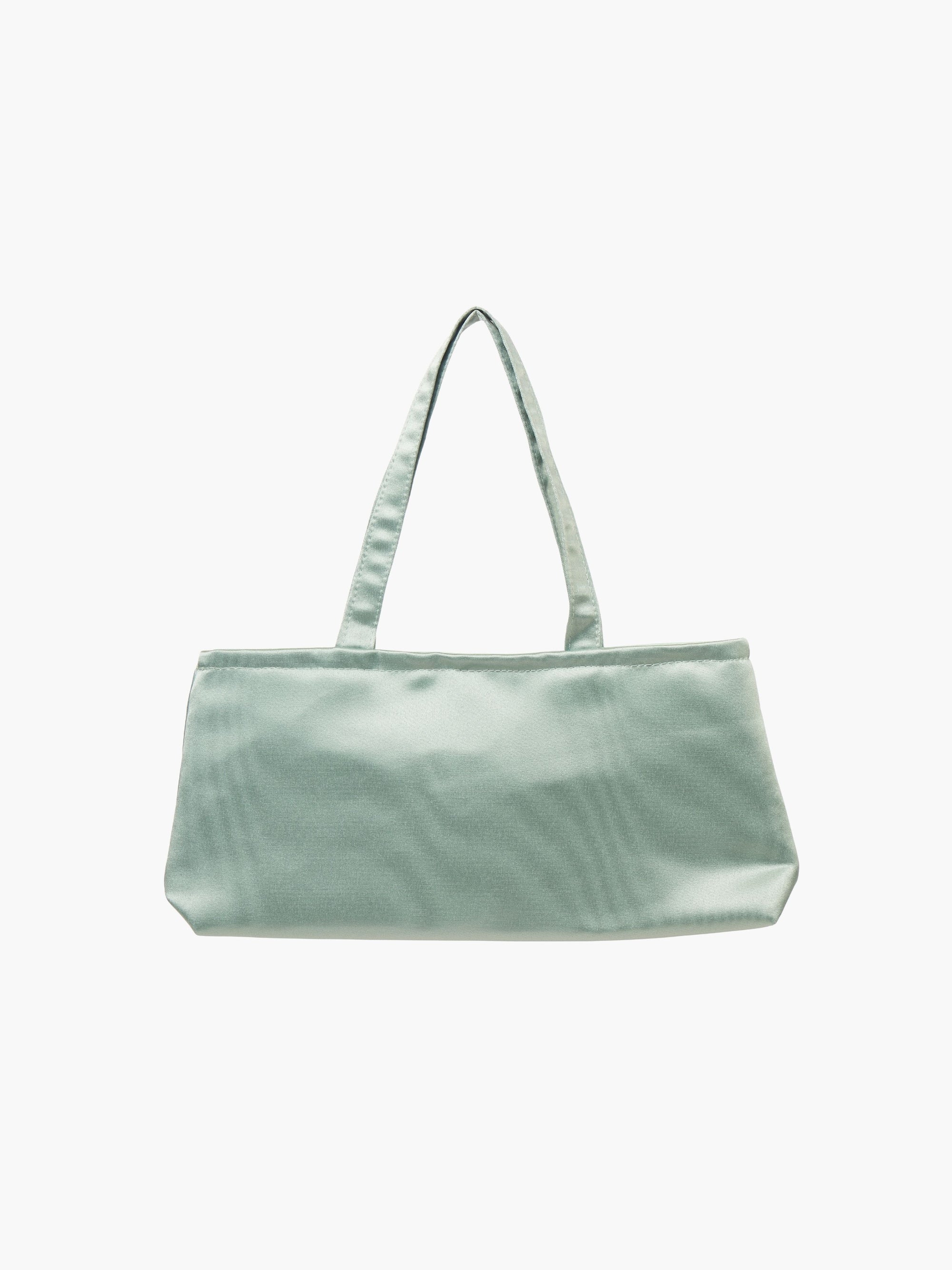 A sea green, rectangular handbag with two thin handles, set against a plain white background. The bag design is simple and elegant.