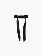 back view of a black satin bow hair clip with a silver crocodile clip on a white background