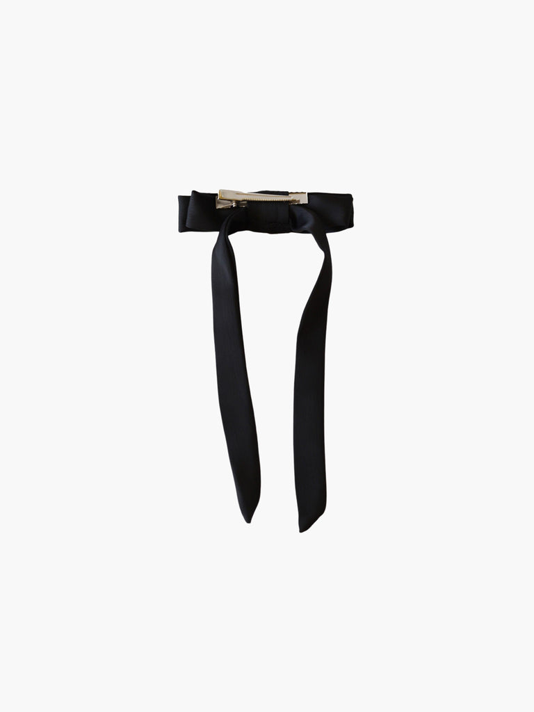 back view of a black satin bow hair clip with a silver crocodile clip on a white background