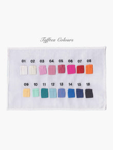 Colour swatch chart with 16 taffeta colours on a white piece of fabric with black embroidered numbers 1-16 above each colour , set on a white background