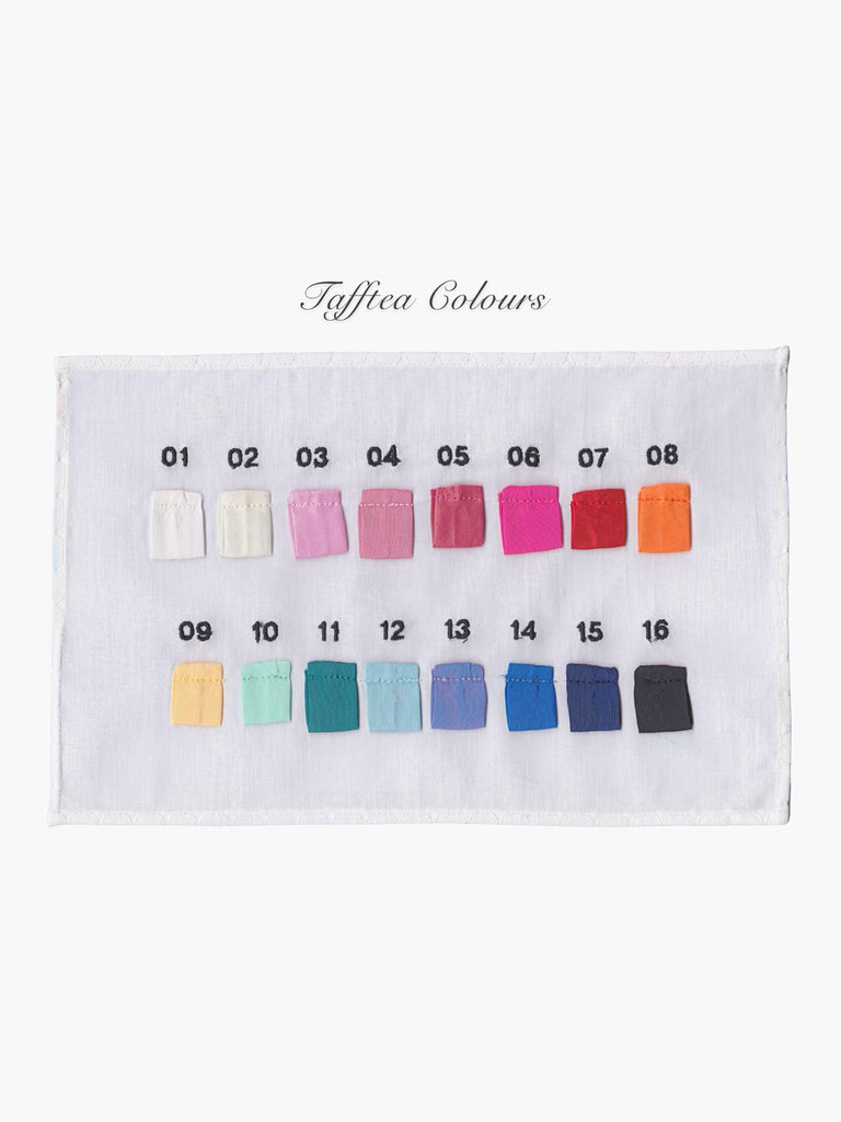 Colour swatch chart with 16 taffeta colours on a white piece of fabric with black embroidered numbers 1-16 above each colour , set on a white background