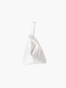White satin knot bag against a plain white background. The elegant bag has a twisted handle and sleek, glossy fabric, exuding a chic, minimalist style.