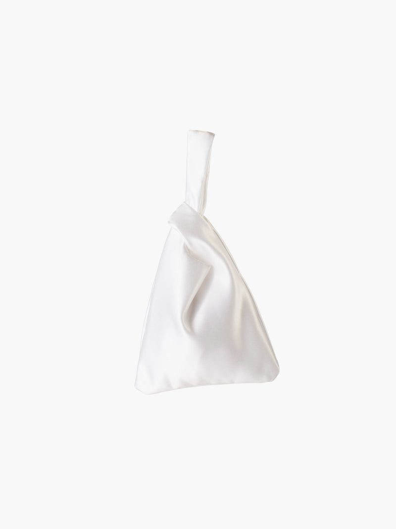 White satin knot bag against a plain white background. The elegant bag has a twisted handle and sleek, glossy fabric, exuding a chic, minimalist style.