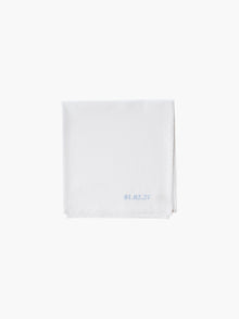A white cotton embroidered square handkerchief, embroidered with the date in blue.