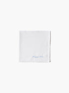 A white cotton embroidered square handkerchief, embroidered with "happy tears" in blue.