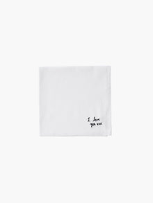 A white cotton embroidered square handkerchief, embroidered with "I love you" in black.