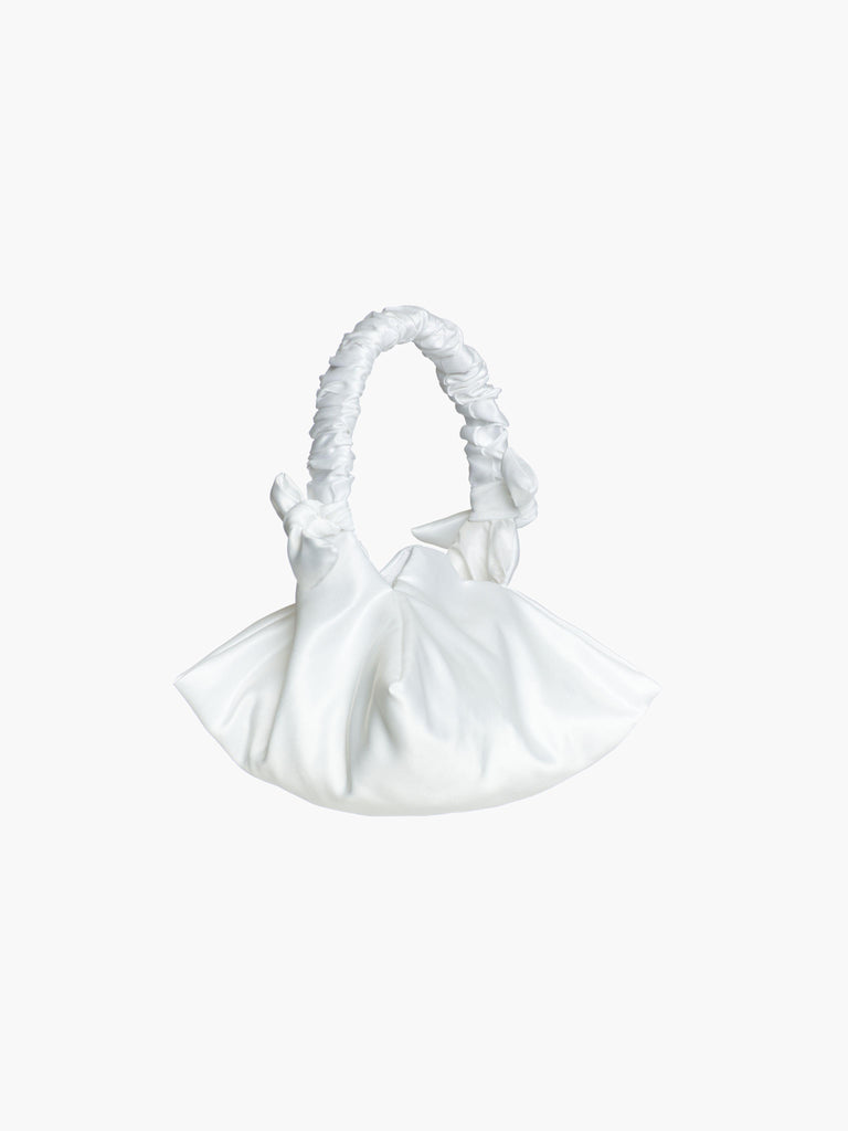 White satin ruched handle handbag with decorative bows, set on a white background