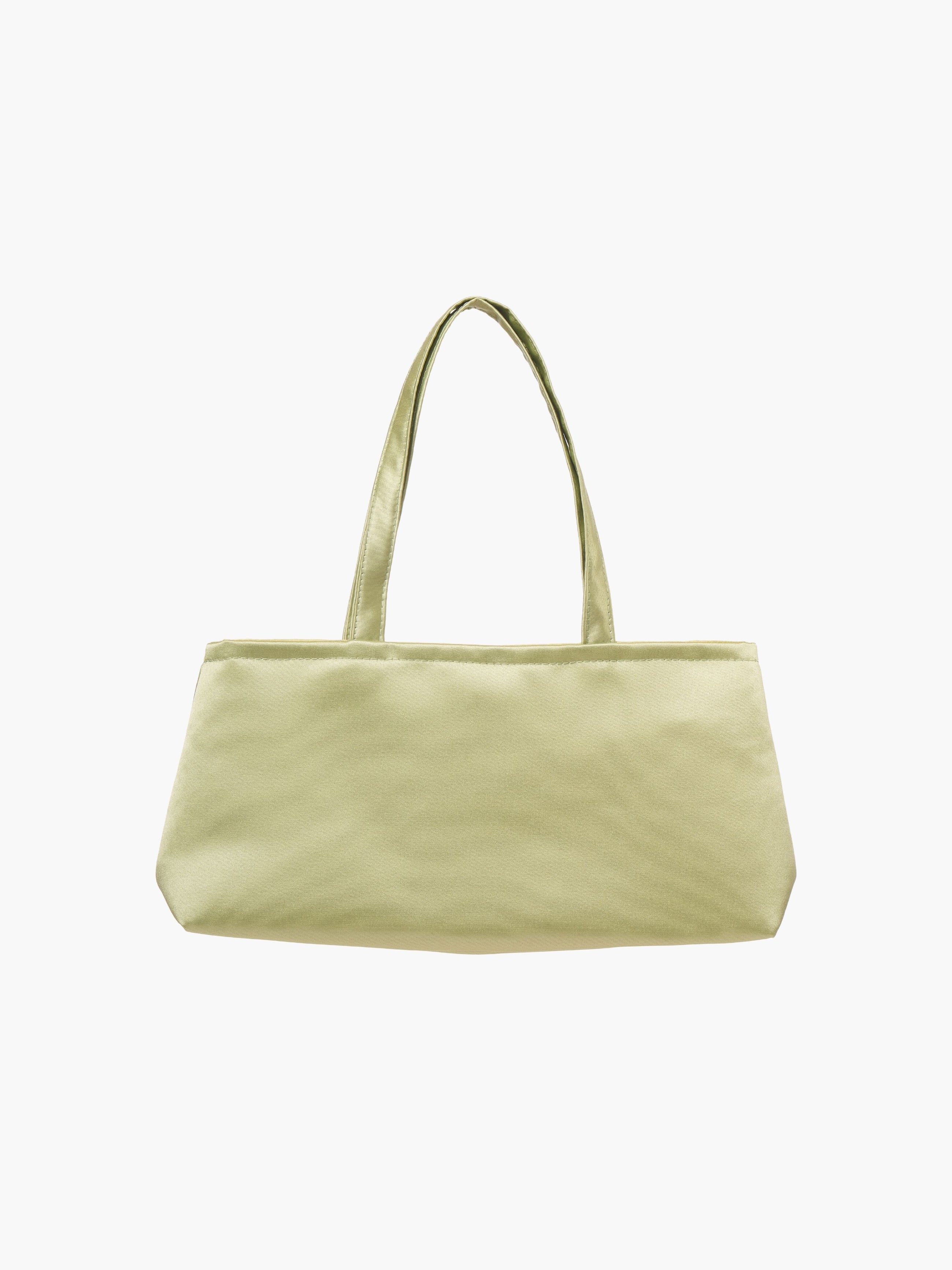 Light green rectangular tote bag with dual handles on a white background. The fabric is smooth, giving a modern and minimalist feel.