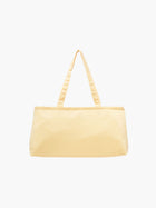 A yellow satin baguette handbag with two handles. 