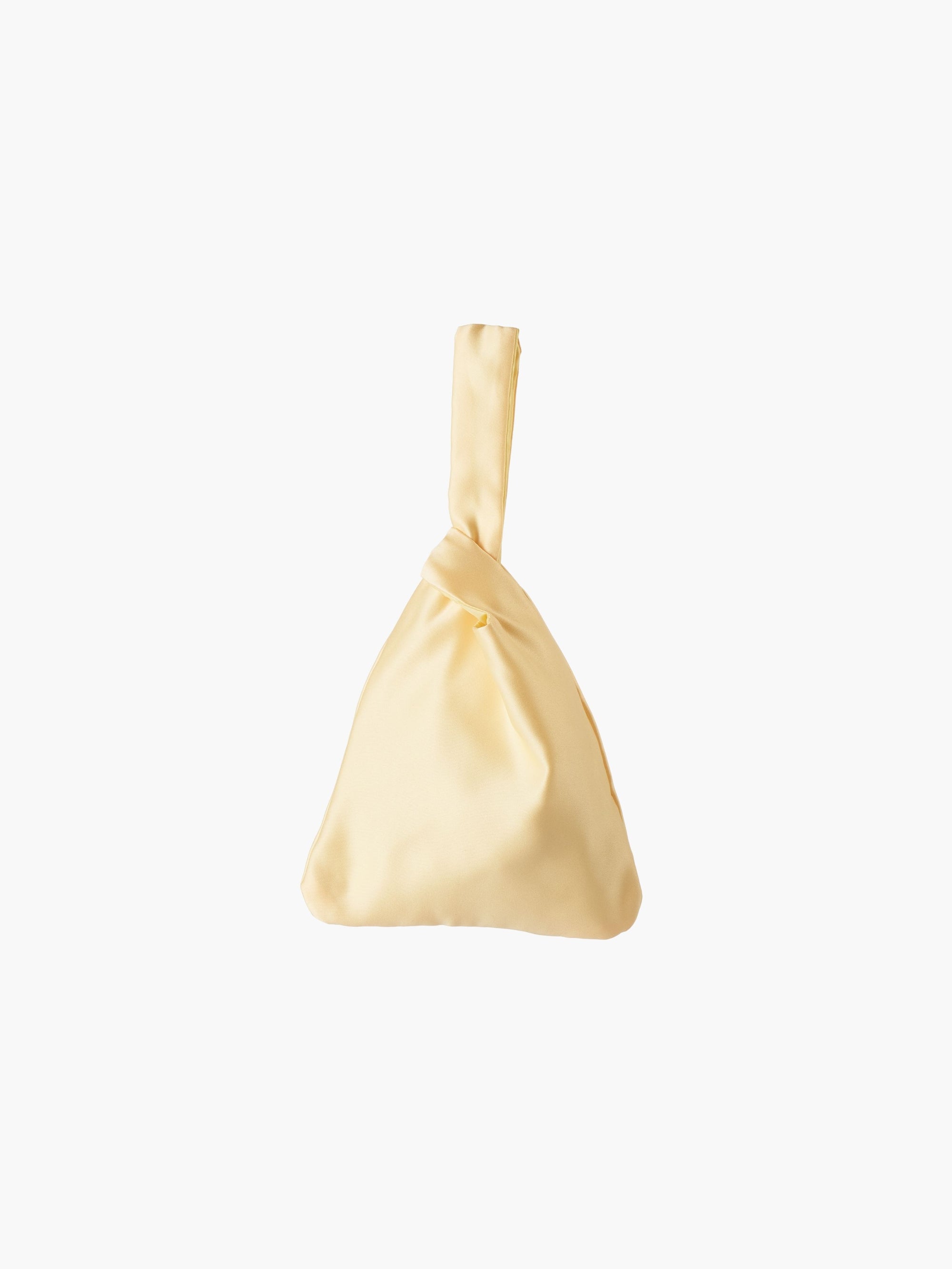 Yellow satin knot bag against a plain white background. The elegant bag has a twisted handle and sleek, glossy fabric, exuding a chic, minimalist style.